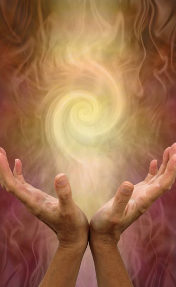 Cupped hands beneath a spiral of golden light